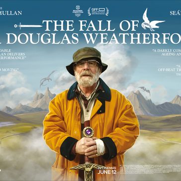 man standing in the middle holding a sword with mountains in the background.