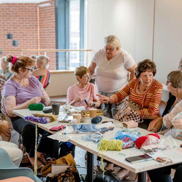 K2Togs knitting group sat around a table.