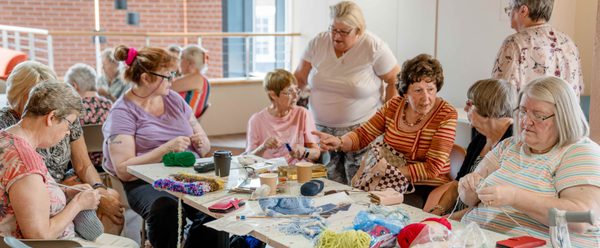 K2Togs knitting group sat around a table.