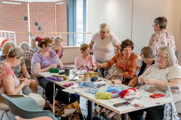 K2Togs knitting group sat around a table.