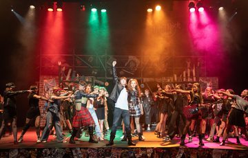 RYC performing on stage 'We Will Rock You'