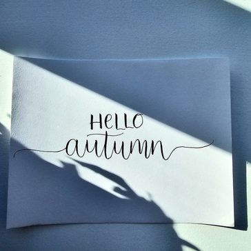 Hello Autumn written in calligraphy.
