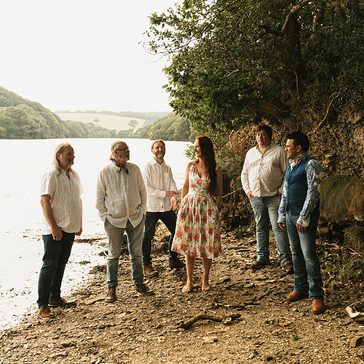 Gigspanner Big Band standing on the side of a lake.