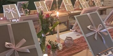 Multiple canvas with bows around them.