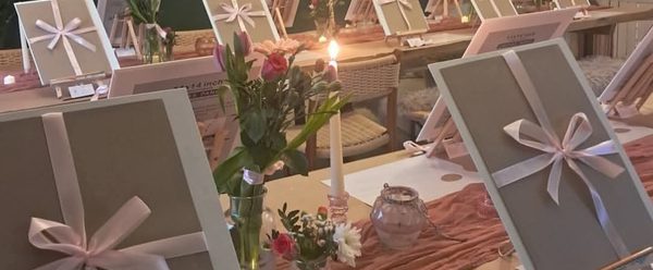 Multiple canvas with bows around them.