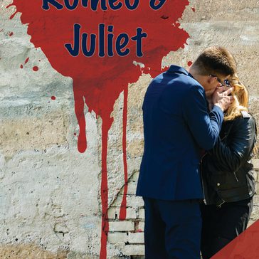 Romeo and Juliet on the wall in the background with 2 people kissing.