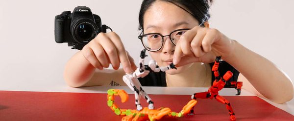 Girl moves figures with her hands