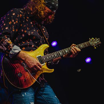 Man playing a guitar.