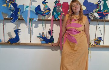 Artist leading the pom pom workshop.