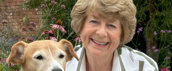 Pam with a dog and her latest book.