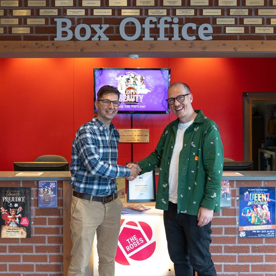 Councillor Stanley and Derek Bond shaking hands in front of Box Office.