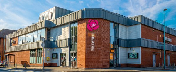 The Roses Theatre building on a sunny day.