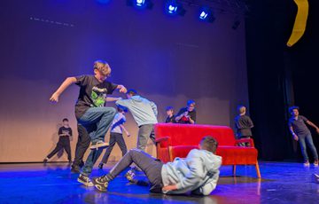 Children on stage in the middle of a performance.
