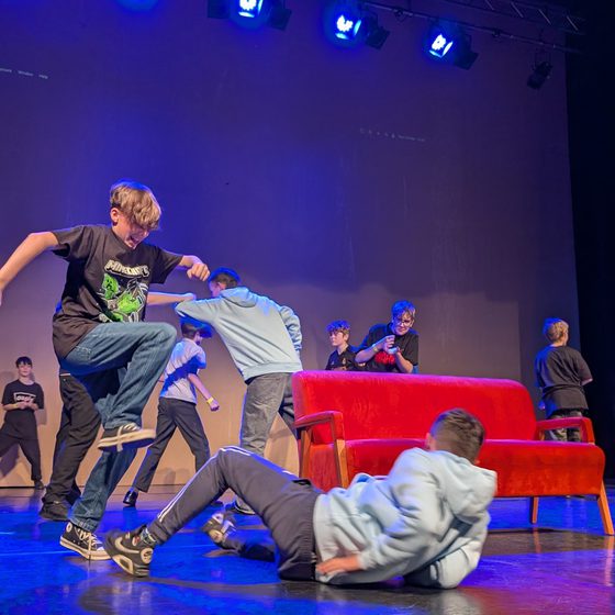 Children on stage in the middle of a performance.