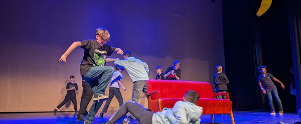 Children on stage in the middle of a performance.